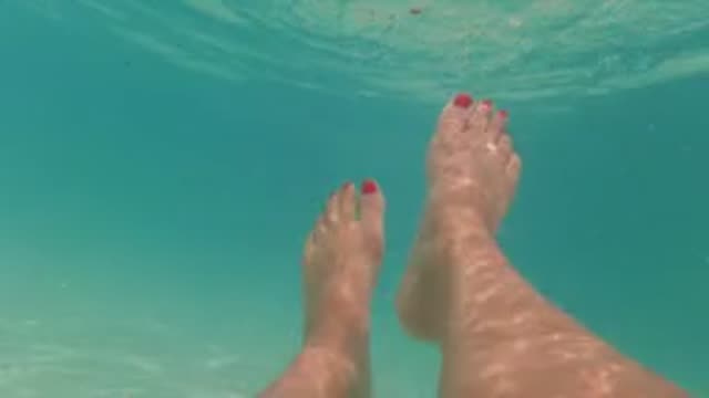 BAJA CALIFORNIA MEXICO-2022: Feet with Red Toenails in a Swimming Pool, Underwater and Above