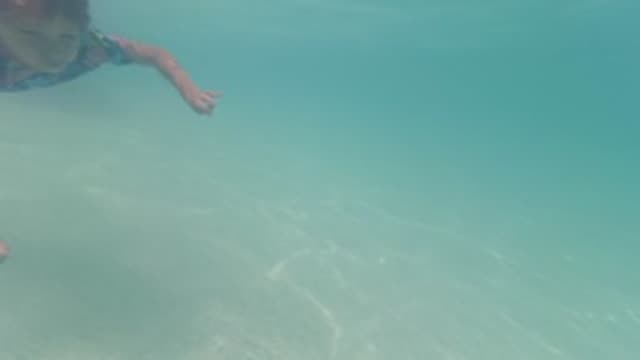 BAJA CALIFORNIA MEXICO-2022: Child Swimming Underwater in Shallow Clear Water
