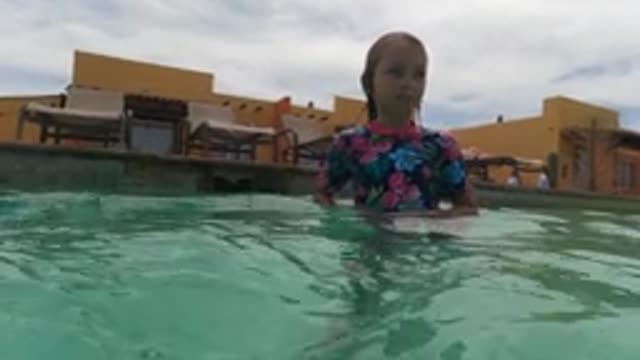BAJA CALIFORNIA MEXICO-2022: Child Playing in a Pool with Lounge Chairs