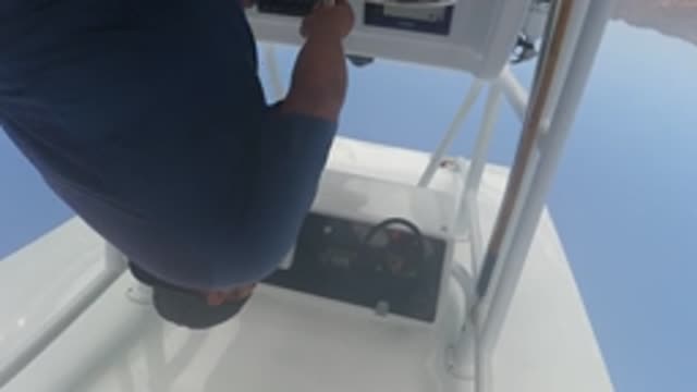 BAJA CALIFORNIA MEXICO-2022: Man Adjusting Boat Console Controls
