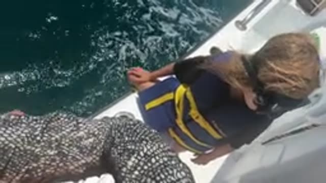 BAJA CALIFORNIA MEXICO-2022: Child in Life Jacket Observing Ocean From Boat Deck