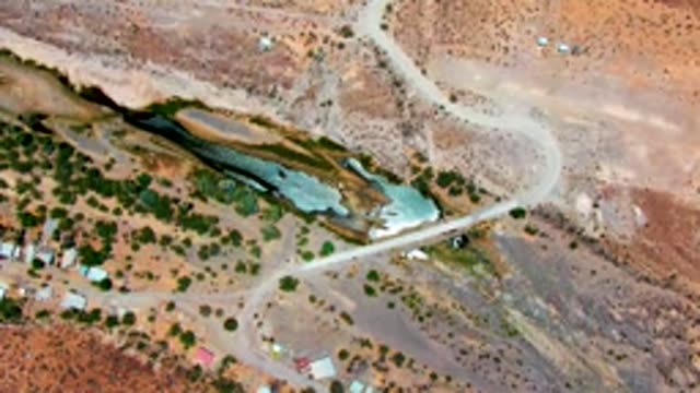 SAN JUANICO BCS MEXICO-2022: Vehicle Traveling Along Winding Dirt Road in Dry Terrain