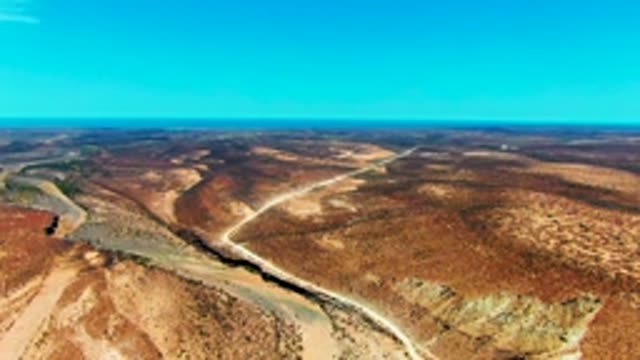 SAN JUANICO BCS MEXICO-2022: Vehicle Moving Along Arid Winding Road