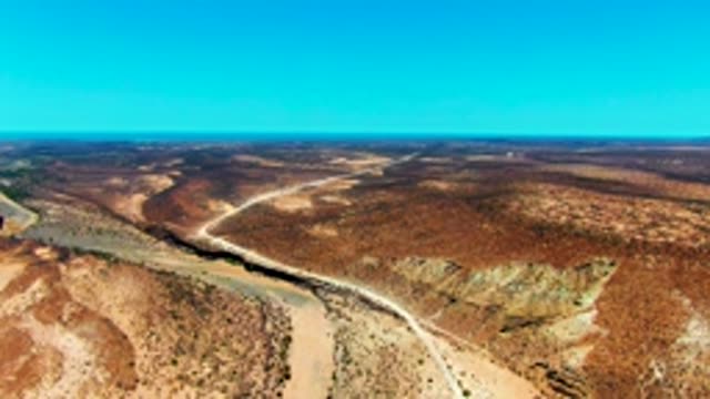 SAN JUANICO BCS MEXICO-2022: Winding River and Road Through Arid Desert
