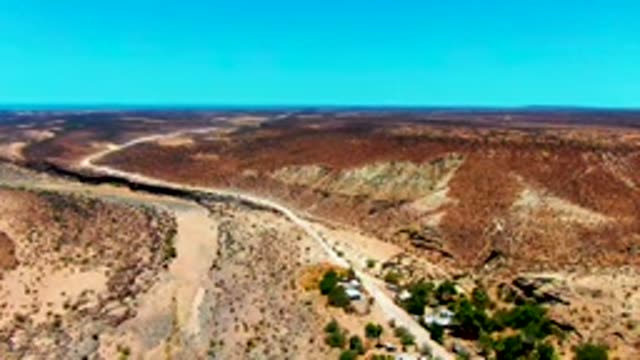 SAN JUANICO BCS MEXICO-2022: Vehicle Moving Along Desert Road near Dry River