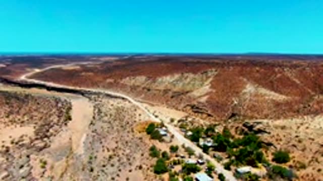 SAN JUANICO BCS MEXICO-2022: Winding Desert Road and Small Settlement Aerial