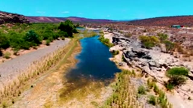 SAN JUANICO BCS MEXICO-2022: River Flowing Through Arid Rocky Terrain
