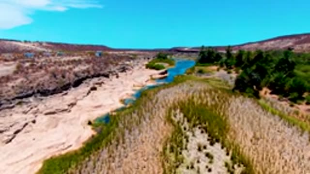 SAN JUANICO BCS MEXICO-2022: Arid Valley River with Green Patches and Rocky Banks