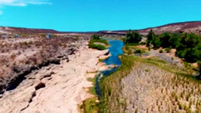SAN JUANICO BCS MEXICO-2022: River Winding Through Arid Rocky Terrain