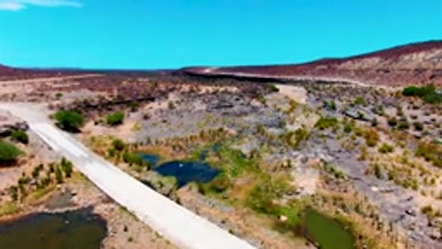 SAN JUANICO BCS MEXICO-2022: Bridge Moving Out Over Arid Landscape