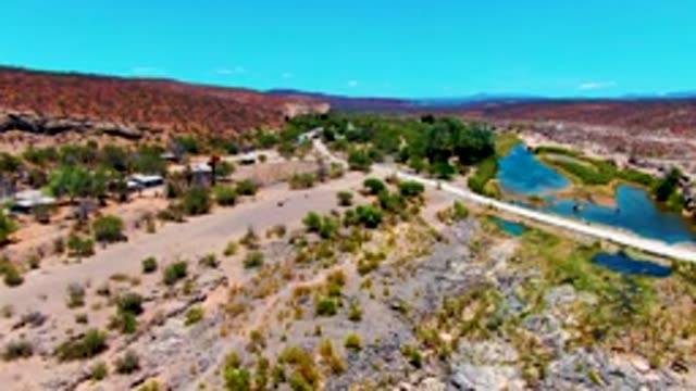 SAN JUANICO BCS MEXICO-2022: Vehicle Driving on Dry Rocky Road near Small Water Body