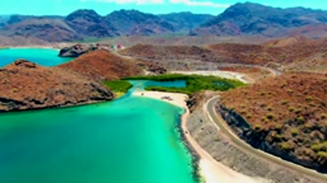 PLAYA SANTISPAC BCS MEXICO-2022: Coastal Road Winding Along Turquoise Bay and Arid Hills
