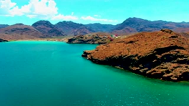PLAYA SANTISPAC BCS MEXICO-2022: Rocky Coastline with Turquoise Waters and Distant Mountains