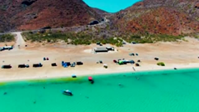 PLAYA SANTISPAC BCS MEXICO-2022: Vehicles Departing a Mountain-encircled Sandy Beach