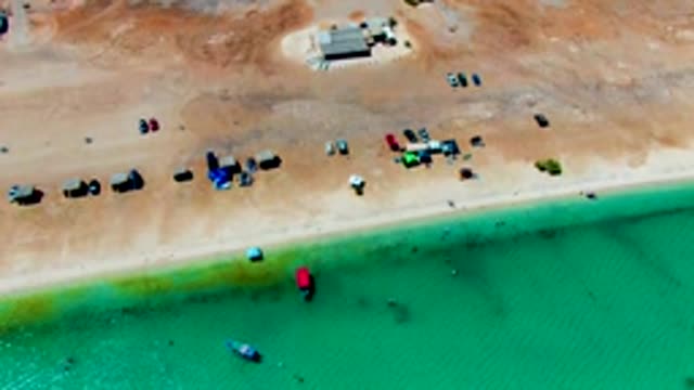 PLAYA SANTISPAC BCS MEXICO-2022: Sandy Beach with Parked Cars and Shifting Turquoise Water