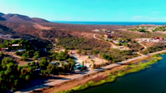 MULEGE BCS MEXICO-2022: Arid Landscape with Road and Waterway Near Ocean