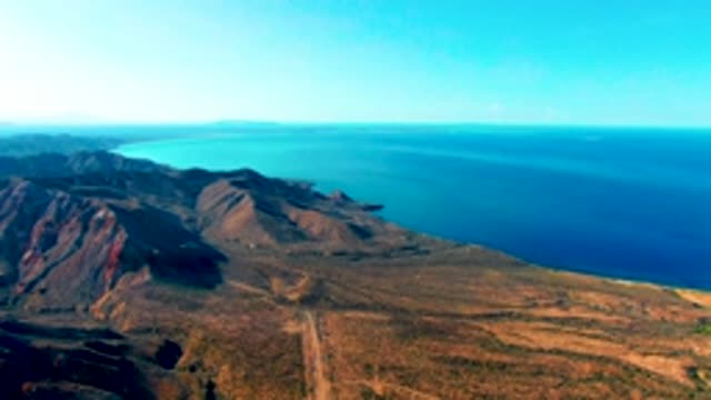 MULEGE BCS MEXICO-2022: Vehicle Traveling Along Coastal Mountain Road