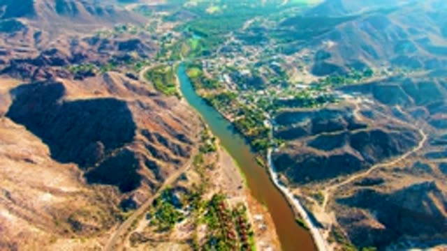 MULEGE BCS MEXICO-2022: River Winding Through Mountain Valley with Settlement