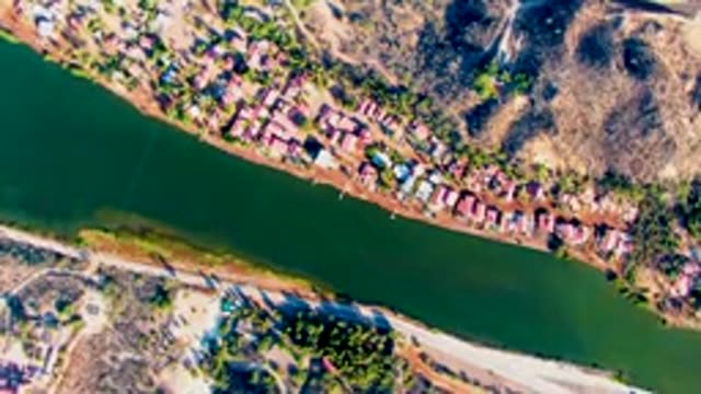 MULEGE BCS MEXICO-2022: Riverbank Village with Moving Vehicle on Road