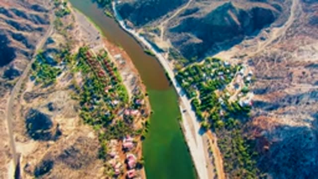 MULEGE BCS MEXICO-2022: River Meandering Through Arid Hills with Roads and Settlements
