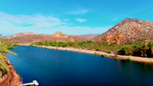 MULEGE BCS MEXICO-2022: Panning View of Lake and Road Along Mountainous Shore