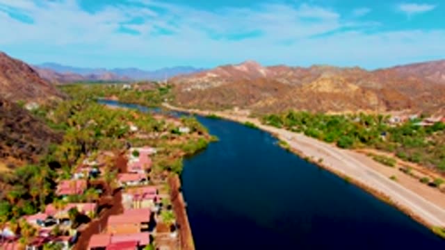 MULEGE BCS MEXICO-2022: Vehicle Moving Along Canal Road in Desert Landscape