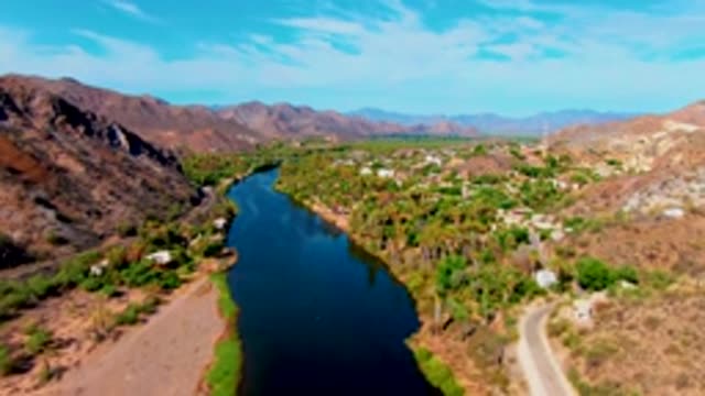 MULEGE BCS MEXICO-2022: Winding River Through Arid Hills and Small Settlements
