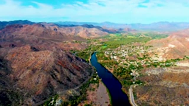 MULEGE BCS MEXICO-2022: River Winding Through Mountain Valley with Small Town