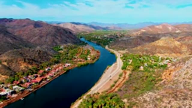 MULEGE BCS MEXICO-2022: River and Road with Moving Vehicles in Mountain Valley