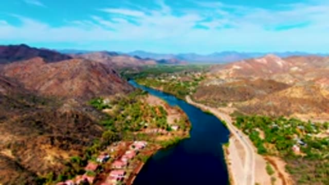 MULEGE BCS MEXICO-2022: River and Road with Moving Vehicle in Mountainous Terrain