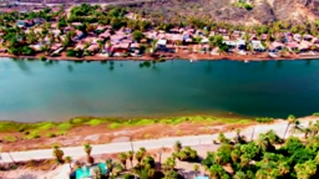 MULEGE BCS MEXICO-2022: Boat Moving on Reservoir Near Residential Area