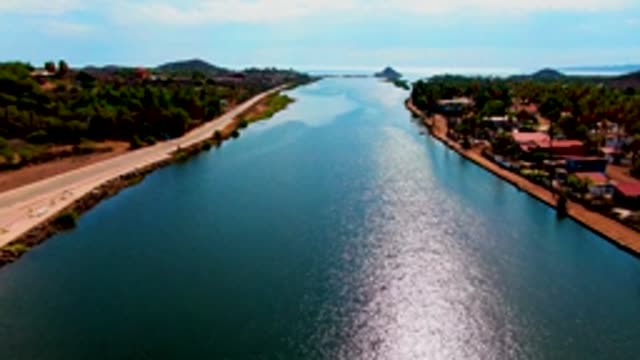 MULEGE BCS MEXICO-2022: Car Moving Along Road Parallel to Waterway