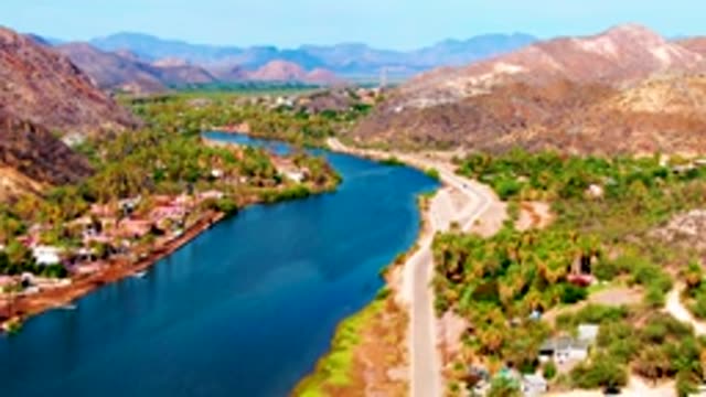 MULEGE BCS MEXICO-2022: Winding River and Road with Moving Vehicle