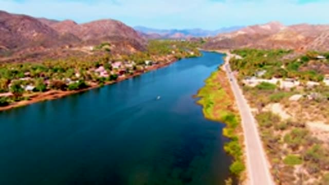 MULEGE BCS MEXICO-2022: Boat and Car Moving Along Waterway and Road