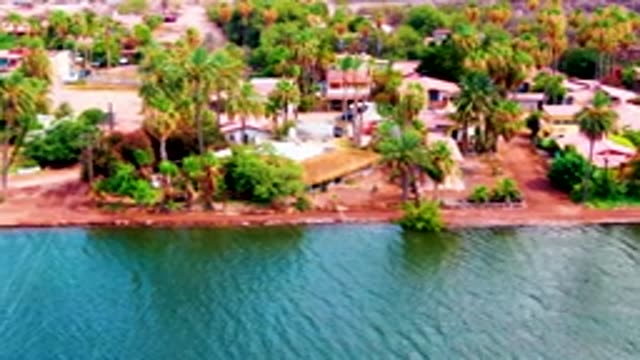 MULEGE BCS MEXICO-2022: Vehicles Traveling Along a Coastal Residential Road