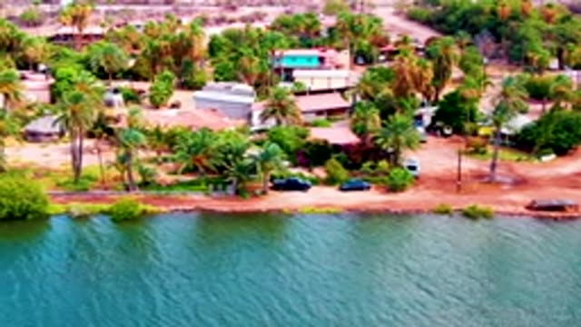 MULEGE BCS MEXICO-2022: Vehicle Moving Along Waterfront Road with Palm Trees