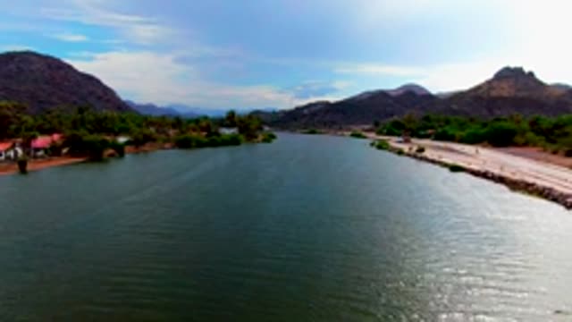 MULEGE BCS MEXICO-2022: Vehicles Moving Along Riverbank Road
