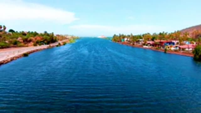 MULEGE BCS MEXICO-2022: Canal Bordered by Road and Buildings