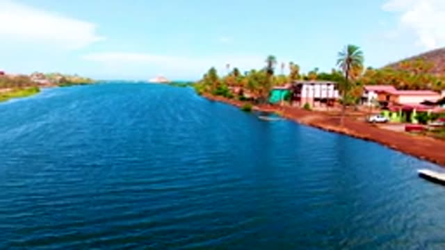 MULEGE BCS MEXICO-2022: Coastal Waterway and Shoreline with Buildings and Palm Trees