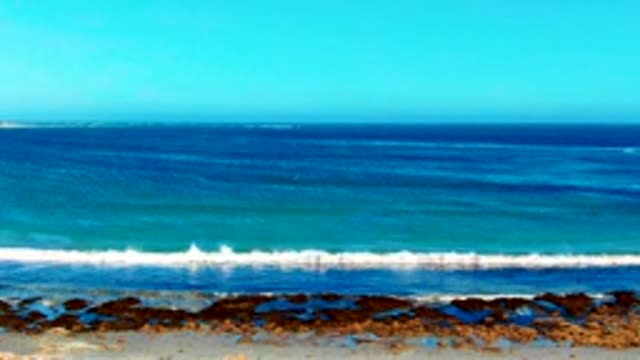Ocean Waves Receding to Reveal Sandy Beach