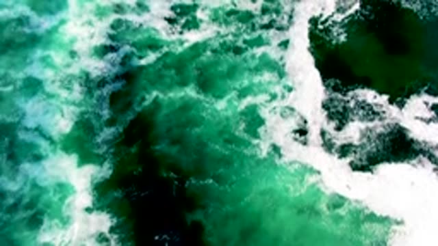 Overhead View of Ocean Waves Breaking in Green Water