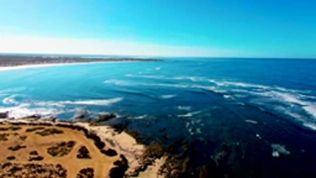 Waves Crashing on Rocky Coast Aerial View