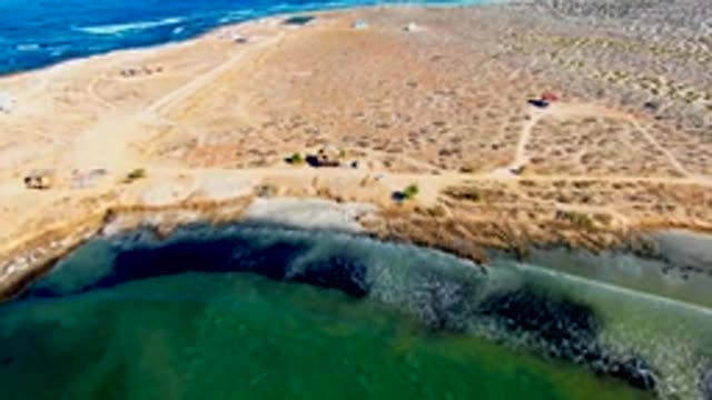Arid Shoreline and Lagoon Aerial Approach