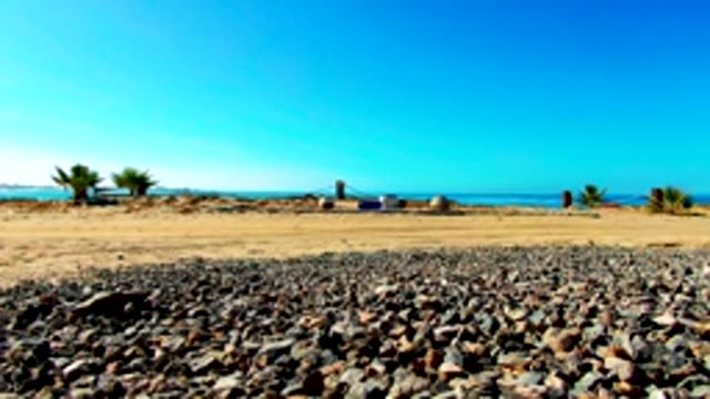 Pebbled Beach with Distant Figure Walking