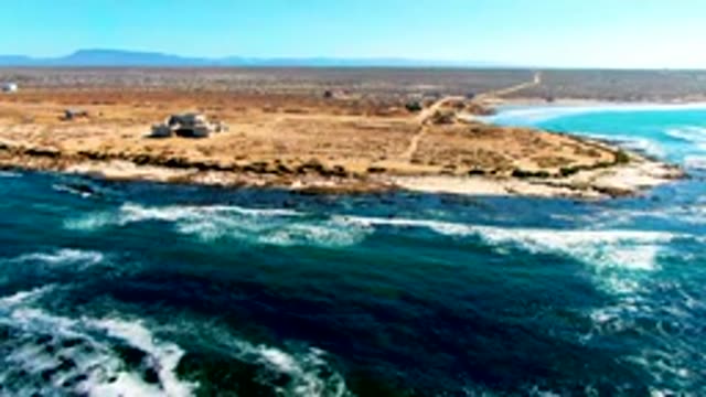 Desert Coast with Ocean Waves and Small Building