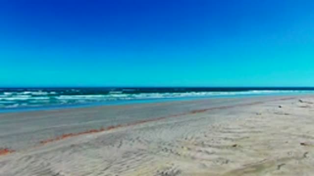 Sandy Beach and Ocean Waves From Above