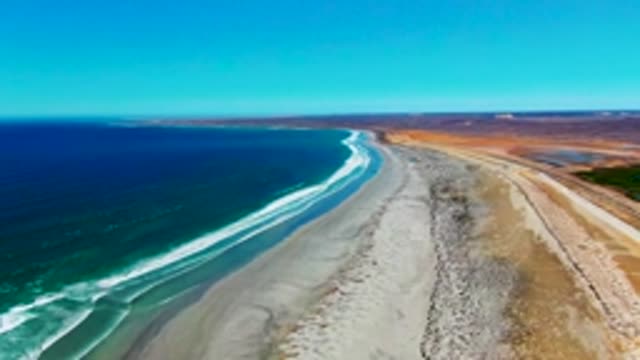 Gentle Ocean Waves Along Sandy Shoreline