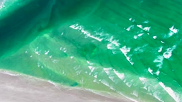 Gentle Ocean Waves Approaching Sandy Beach