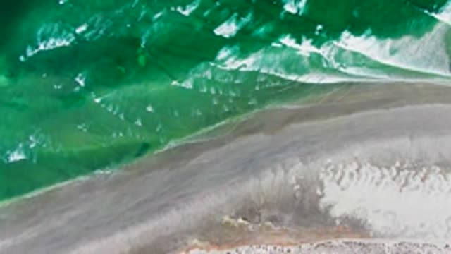 Waves Advancing and Receding on Sandy Shore