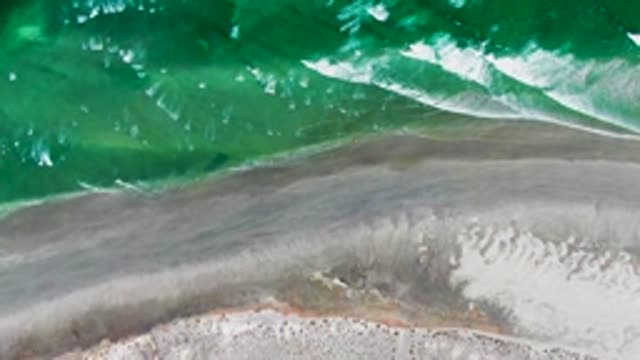 Ocean Waves Rolling Onto Sandy Shore